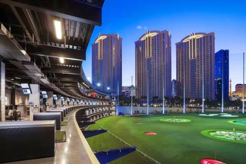 a golf course in a city with tall buildings at The Signature at MGM Grand by Owners Direct in Las Vegas