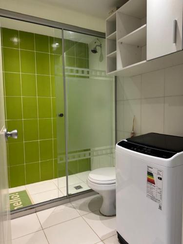 a bathroom with a toilet and a glass shower at 7th floor Live, Laugh and Relax in Cochabamba