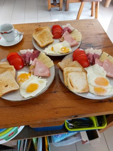 two plates of eggs and bread and tomatoes on a table at Tiny House Kety in Krupa