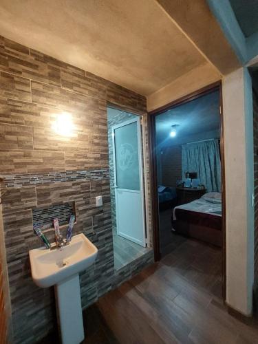 a bathroom with a sink and a mirror and a bed at departamento 2 en condominio in Amecameca de Juárez