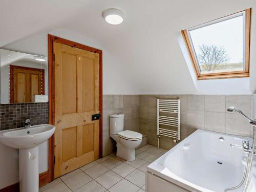 a bathroom with a toilet and a sink and a window at 4 Bed in Wareham oc-dc176 in West Lulworth