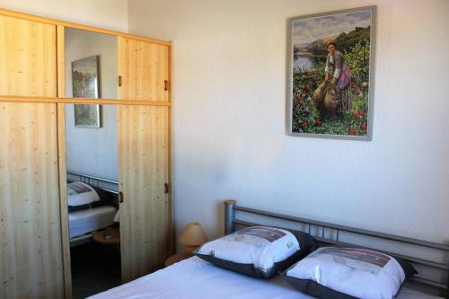 a bedroom with a bed and a painting on the wall at Chez David in La Celle-sous-Gouzon