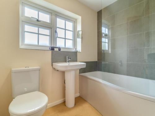 a bathroom with a toilet and a sink and a bath tub at 3 Bed in Brancaster Staithe oc-kt150 in Brancaster