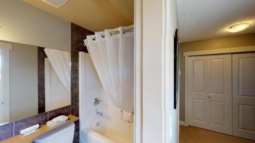 a bathroom with a tub and a toilet and a sink at Sooke Harbour Penthouse in Sooke