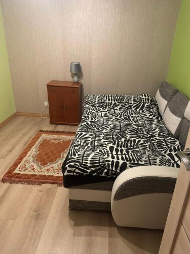 a bedroom with a black and white bed and a rug at Room in Northampton in Great Billing