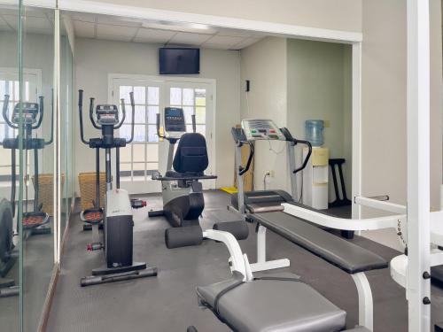 a gym with several treadmills and machines in it at Havelock Hotel in Havelock