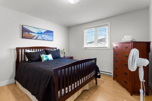 a bedroom with a bed and a dresser and a window at Relaxing 2BR Parking Self Check-In in Torbay