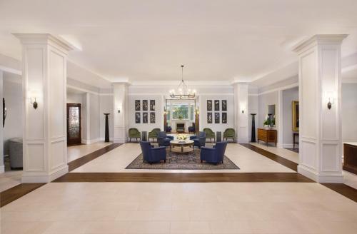 a large living room with couches and a table at Washington Duke Inn & Golf Club in Durham