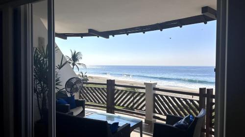 a balcony with a view of the beach and the ocean at VIVO Residences 2 Bedroom Ocean Front Condo 180 degree ocean views in Puerto Escondido