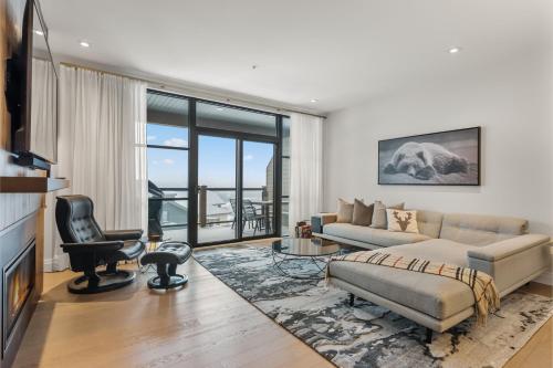 a living room with a couch and a chair at Tremblant Prestige - Horizon 2-204 in Mont-Tremblant