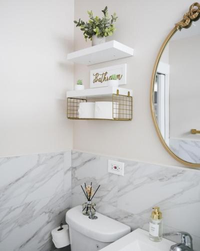 a white bathroom with a sink and a mirror at 2BR w/ Workspace - Coffee Bar - Near Transit in Chicago