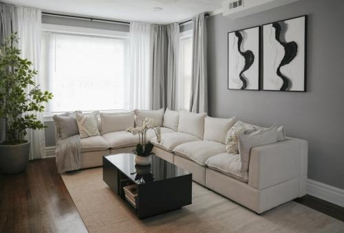 a living room with a white couch and a coffee table at 2BR w/ Workspace - Coffee Bar - Near Transit in Chicago