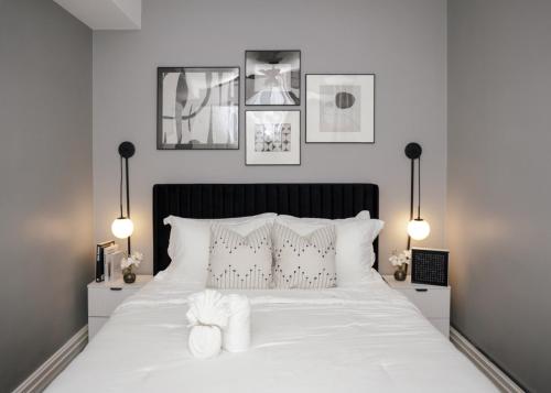 a bedroom with a white bed with two lamps at 2BR w/ Workspace - Coffee Bar - Near Transit in Chicago