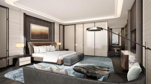 a bedroom with a bed and a couch and a table at Crowne Plaza Linyi Olympic Sports Centre by IHG in Linyi