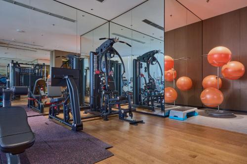 a gym with exercise equipment and a glass wall at Crowne Plaza Phnom Penh by IHG in Phnom Penh