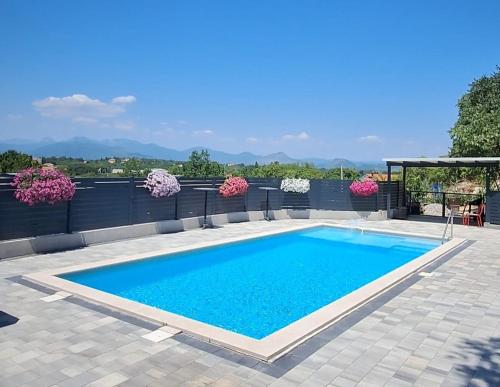 a swimming pool with blue water in a patio at CASA Kovac in Ljubuški