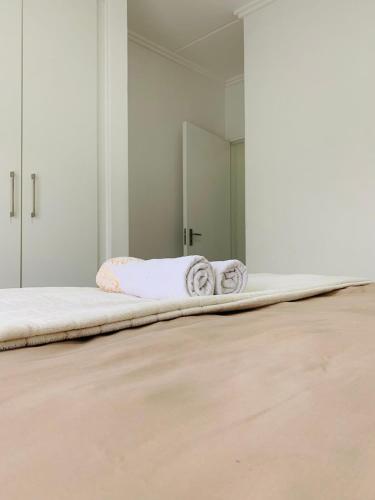 a bed with two towels on it in a room at 2 Bed 2 Bath Private Garden Apartment in Fourways