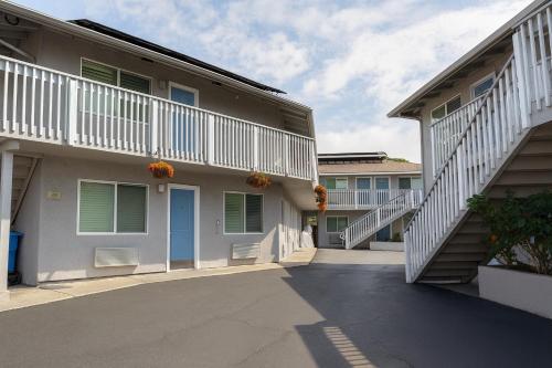 a building with a blue door and some stairs at Pacific Inn Monterey in Monterey
