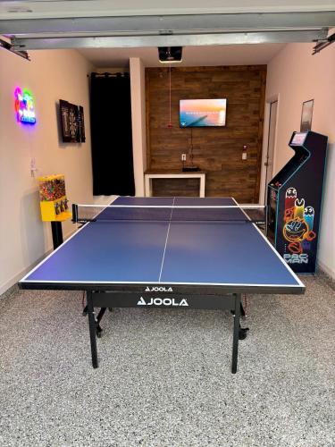 a ping pong table in the middle of a room at Family home near boat launches, beaches, and The Wharf! King bed and pet friendly in Orange Beach