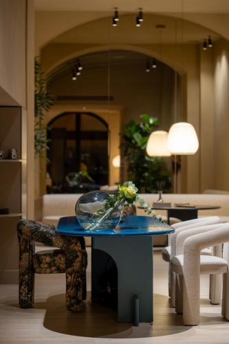 a table with a bowl of flowers on it in a living room at Palazzo Balsamo Boutique Hotel in Palermo