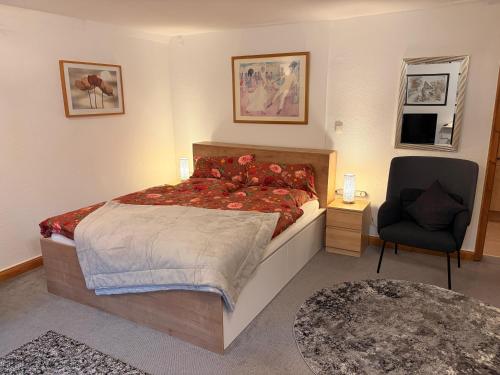 a bedroom with a large bed and a chair at Sophie in Lübeck