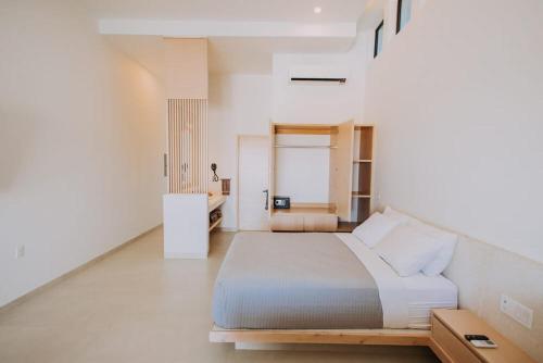 a bedroom with a large bed in a white room at 605 Tower Downtown Cabo in Cabo San Lucas