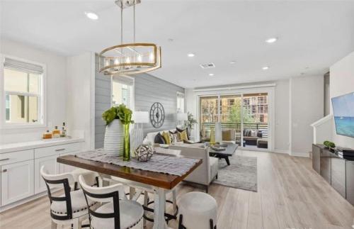 a kitchen and living room with a table and chairs at Marbella Lane Chic Stay In Prime Irvine Area in Lake Forest