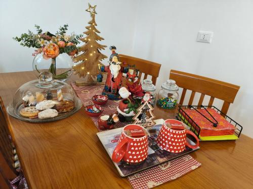 a dining room table with a christmas tree and decorations at La Casa nel Borgo - Licenza in Licenza
