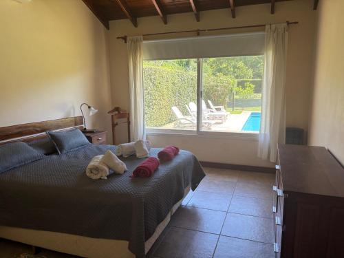 a bedroom with a bed with two stuffed animals on it at Casa en Ing. Maschwitz con gran parque y pileta in Ingeniero Maschwitz