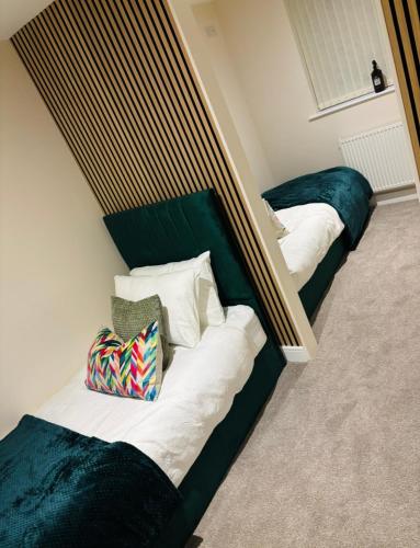 two beds sitting next to each other in a room at Tarn House Apartment South Yorksire in Barnsley