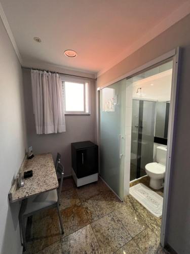 a bathroom with a toilet and a sink and a shower at Motel Segredos (Adults Only) in Guarulhos
