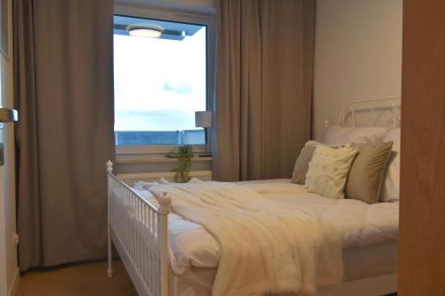 Szpitalna Residence & Garage في سووالكي: سرير أبيض في غرفة بها نافذة