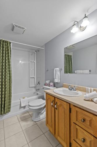 a bathroom with a sink and a toilet and a mirror at Modern Manor Studio WiFi Parking in St. John's