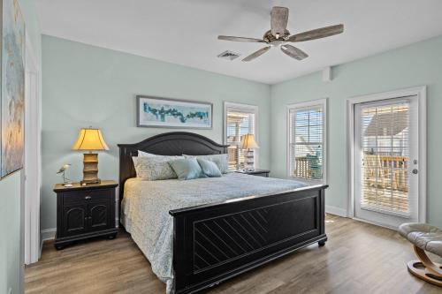 a bedroom with a bed and a ceiling fan at Penthouse in Atlantic Beach