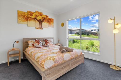 a bedroom with a bed and a window at Comfy Home in Deebing Heights in Loamside