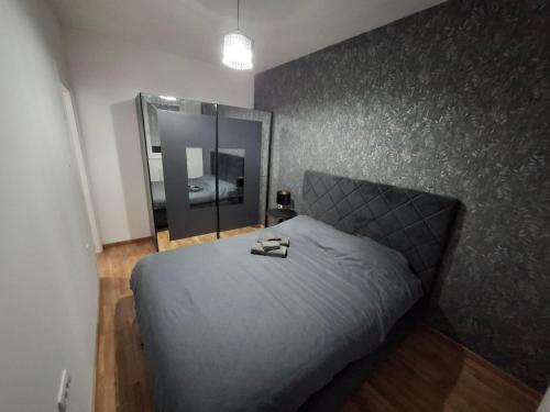 a bedroom with a bed and a large mirror at Eleon in Novi Sad