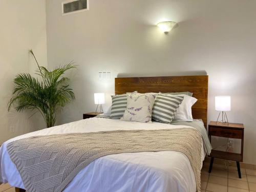 a bedroom with a large bed with two lamps on tables at Garden and Pool Casita in La Paz