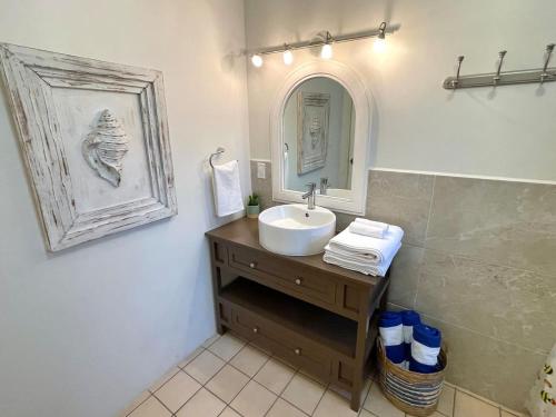 a bathroom with a sink and a mirror at Garden and Pool Casita in La Paz