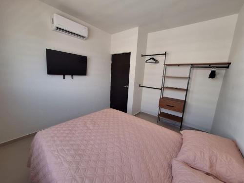 Los BledalesCasa Nopal的一间有床和电视的卧室