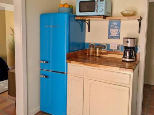 a blue refrigerator in a kitchen with a counter at Mid-century marvelous 1 bed, pets welcome in Las Cruces