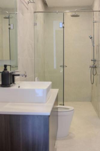 a bathroom with a sink and a shower and a toilet at Barad Lux Villa in Mae Haad