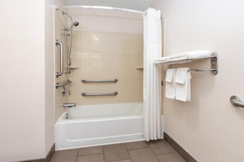 a bathroom with a bath tub and a shower at Candlewood Suites Midland by IHG in Midland