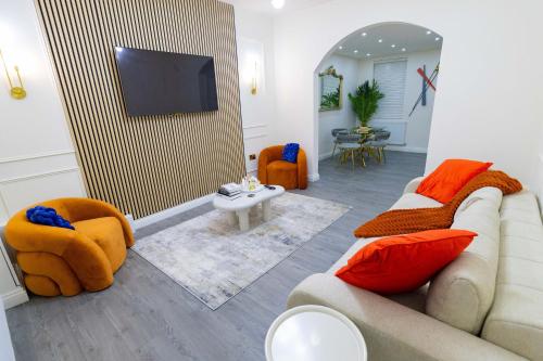 a living room with a couch and a flat screen tv at Paradise Nestv in Manchester