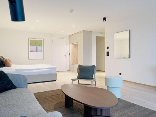 a living room with a bed and a table at Hotel Murten in Murten