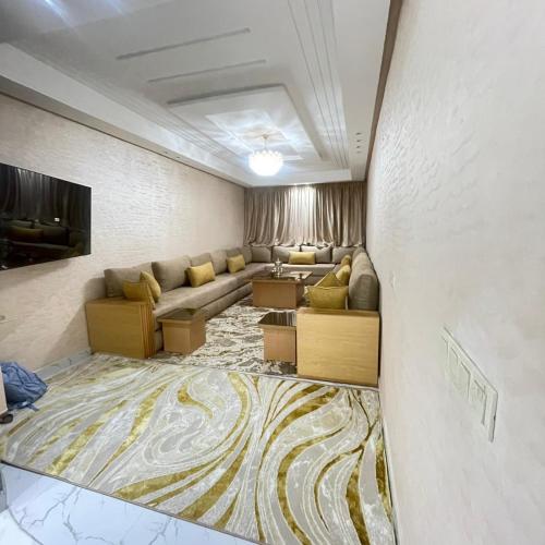 a living room with a couch and a tv at Prime stay downtown Meknes in Meknès