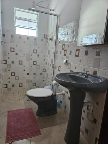 a bathroom with a sink and a toilet at Pousada Santo Agostinho in Extrema