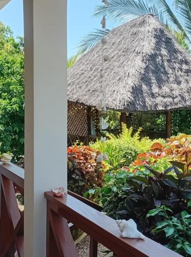 a view of a garden from a balcony at Kijani House in Banda Kuu