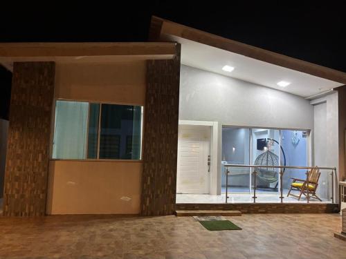 a building with a balcony with a mannequin in the window at Alojamiento en Ayangue in Santa Elena