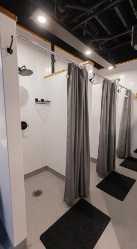 a row of gray curtains in a room with mats at The Cambie Hostel Gastown in Vancouver