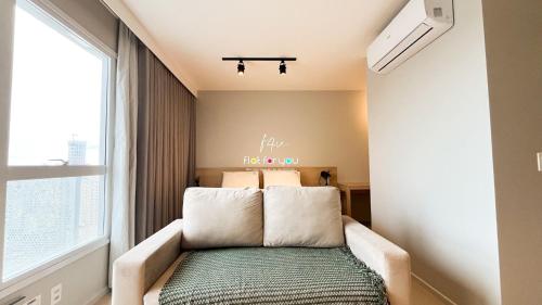 un sofá en una habitación con ventana en #2002T# Lindo studio Jd. Goiás., en Goiânia